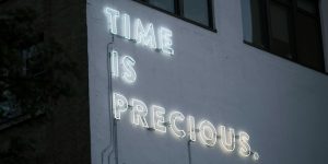 Time Is Precious Sign on Building