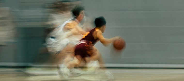 Two basketball players playing basketball